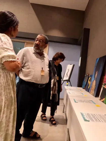 My first in-person exhibition in Mumbai. Here, I am talking to visitors about my 'Walking Towards Acceptance' series. It was nerve-wracking to share such personal work, but the connections I made were incredibly meaningful.