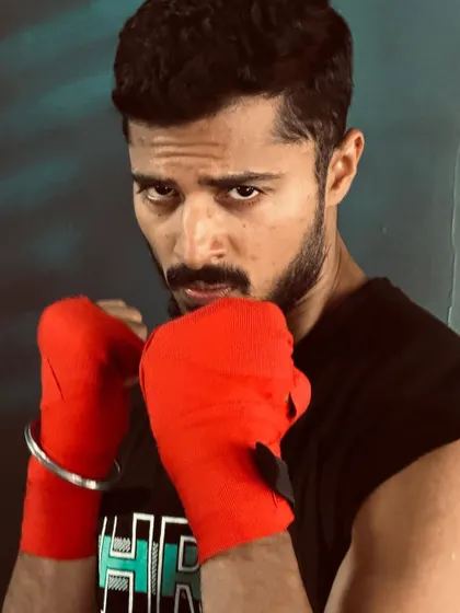 Ready to fight. This boxing-themed shot shows my intense and focused side, perfect for sports or athletic brands.