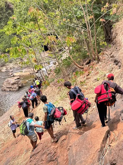 Children from our nature awareness camp trek along a beautiful forest stream in Ulavi, learning about the local ecosystem and enjoying the outdoors.