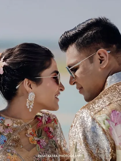 The couple, both in sunglasses, share a happy and stylish moment on the deck of the cruise ship.