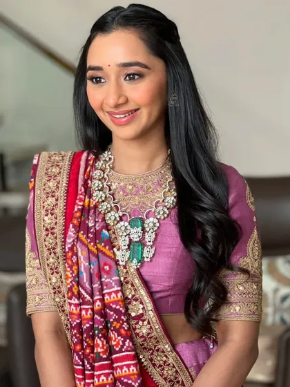 A beautiful smile to complete the look. This makeup style is perfect for traditional ceremonies, offering a balance of reverence and radiance.