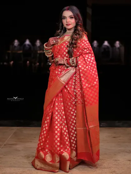 A confident three-quarter portrait in the red saree. The model's pose is elegant and traditional, perfectly suited for the festive occasion.