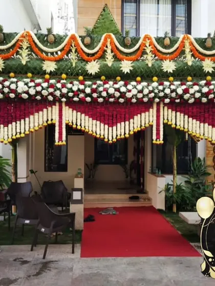 A grand entrance for a traditional South Indian wedding. I constructed this welcome arch using a classic design with pillars made of polished coconuts, intricate floral thoranams, and a roof woven from fresh coconut leaves.