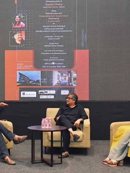 A candid shot from a panel discussion, capturing a moment of engaged conversation between the speakers.