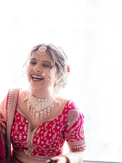 A beautiful, light filled photo of Asreen laughing. This is proof that you can be a radiant bride without layers of heavy makeup.