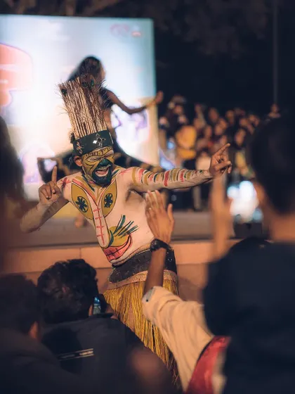A performer interacts with the audience, bringing the energy of the stage directly to the crowd. Capturing these connections is key to telling the full story of an event.