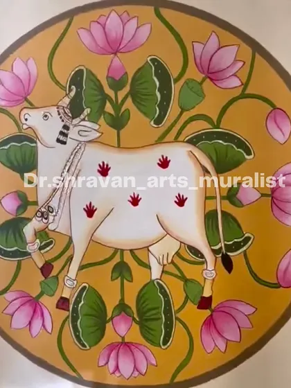 A beautiful Pichwai painting of a sacred cow surrounded by lotuses, all contained within a circular boundary. This design is perfect for adding a touch of elegance to an empty wall.