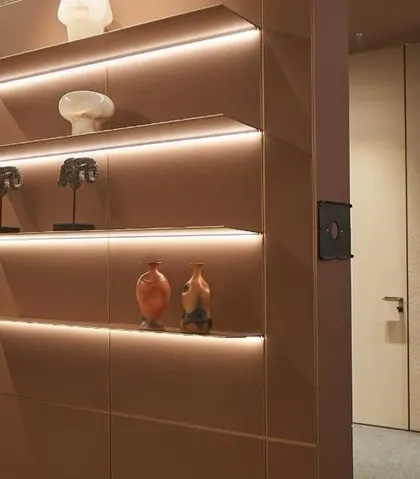 Backlit shelving provides a warm glow and highlights curated objects within the WALTZ 2024 pavilion. This detail demonstrates how we use lighting not just for illumination, but to create mood and draw attention to key features.