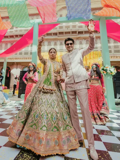 The couple makes a grand, waving entrance at their vibrant Mehendi ceremony.