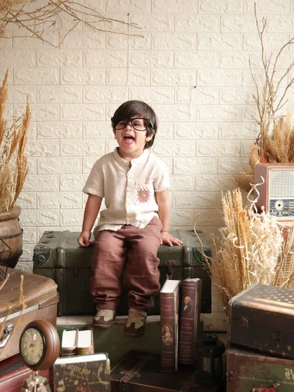 A playful and silly face from our little vintage explorer. These are the fun, candid moments that truly capture a child's personality.