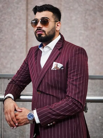 A classic pinstripe suit in a rich maroon color. The double-breasted design adds a touch of old-school power, while the modern tailoring keeps it fresh and relevant for today's boardroom.