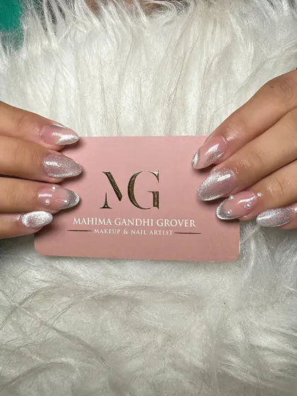 A stunning example of cat eye nail extensions. This design uses magnetic polish to create a shimmering, light-reflecting effect, finished with a glossy top coat for a truly eye catching look.