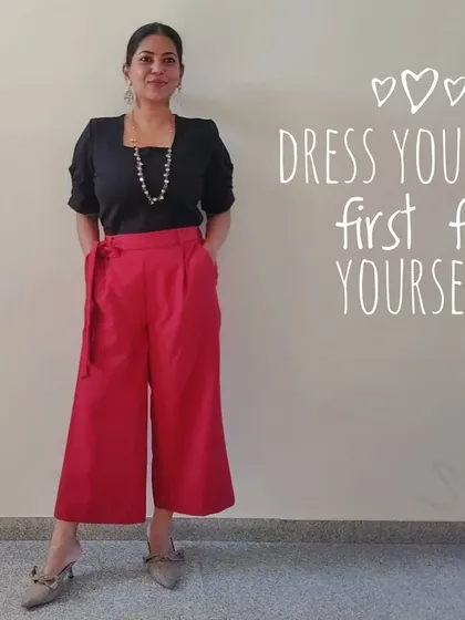 I believe in dressing for yourself, first and foremost. This outfit, with a classic black top and bold red culottes, makes me feel confident and happy, and that's what truly matters.