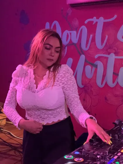A focused moment at the console, with a cool neon sign in the background.