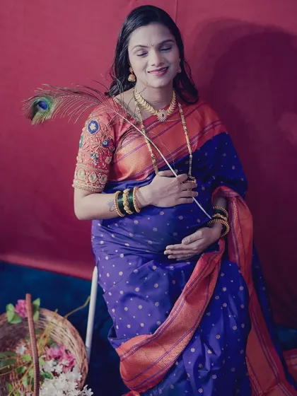 A creative shot with a peacock feather, symbolizing beauty and grace. This is from one of my all-inclusive maternity shoot packages.