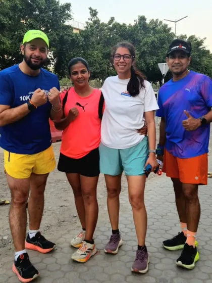 Four of our runners posing after a workout. The mix of individual focus and group support is key to our success.