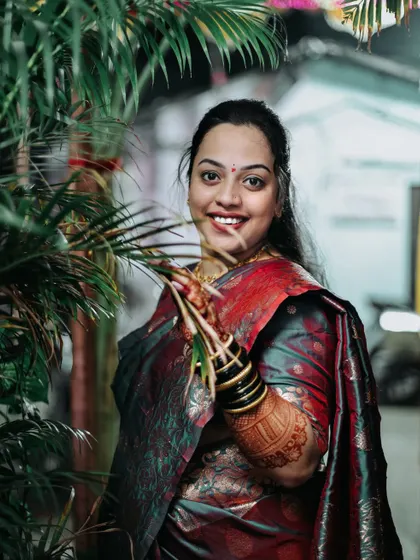 A beautiful portrait of the bride amidst green foliage during her Haldi ceremony.