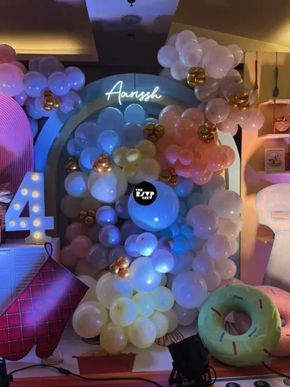 A beautiful balloon-filled backdrop for the baking party, with a neon sign of the birthday girl's name.