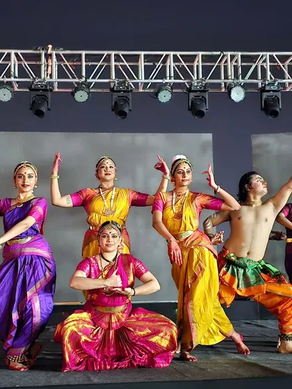 Another angle of the 'Maheswara' troupe, capturing the energy and vibrant costuming of the performance.