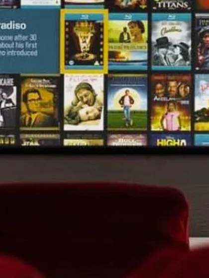 The user interface of a media server is displayed on a large screen, showcasing easy access to a vast collection of films. Our setups integrate smart media players for a seamless browsing and viewing experience.