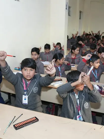 Students raising their hands, full of energy and ready to solve problems during a practice session.