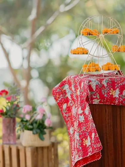 A mini Ferris wheel holding marigold ladoos was one of the playful details at our 'Rajasthani Folklore' Mehendi. It’s these little whimsical touches that make an event memorable.