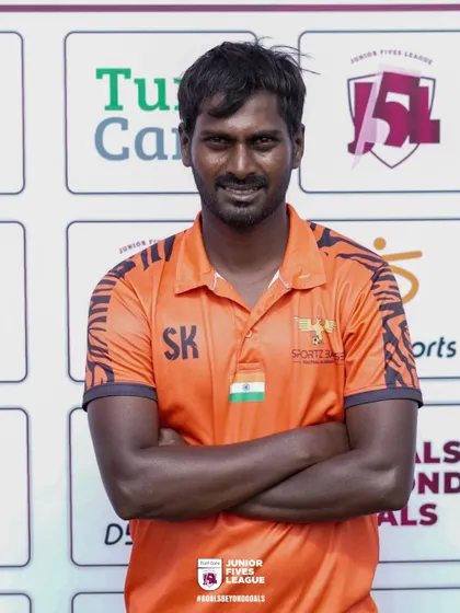 A coach from Sportz Base proudly represents his team. The quality of coaching at the J5L is a major draw for top academies.