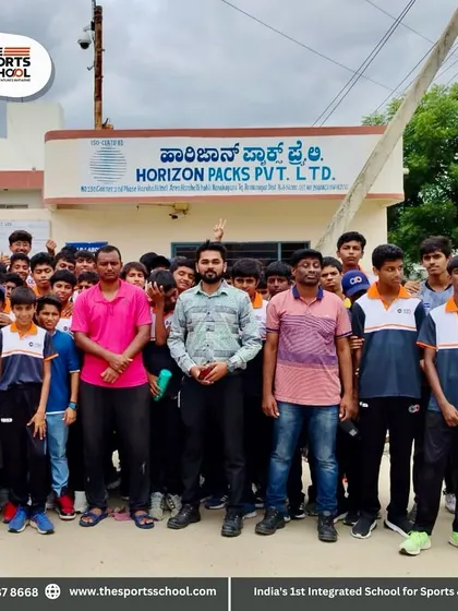 The group of students and teachers pose outside the Horizon Packs factory, marking a successful and educational field trip.