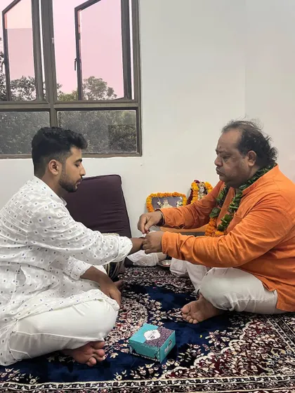 Receiving the sacred thread from my Guru during the 2023 Guru Purnima.