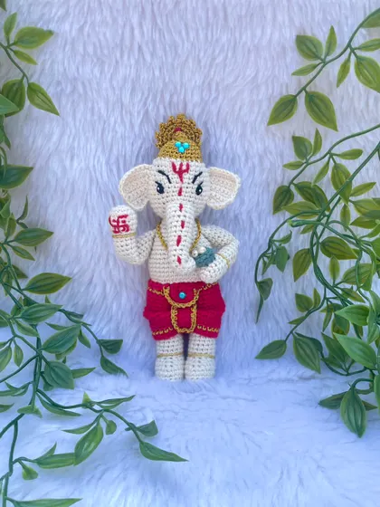 A detailed look at my Lord Ganesh doll. I carefully stitched the details on his trunk, the swastika on his hand, and his golden crown. He is a symbol of new beginnings and removing obstacles.