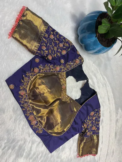 A top-down view of the deep purple blouse, highlighting the contrast with the gold brocade sleeves.