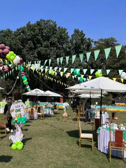 Another perspective of the spacious outdoor jungle party layout, showing the arrangement of tables and decor.