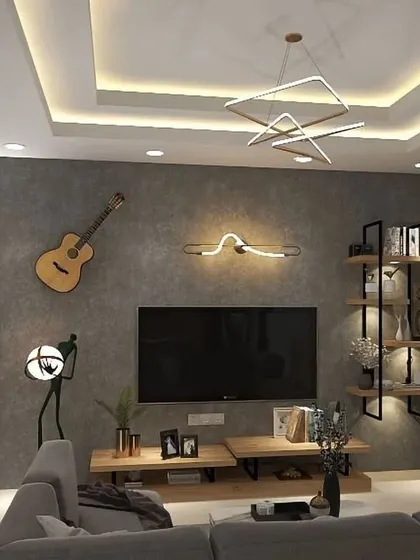 This living room design incorporates personal touches like a guitar on the wall, creating a space that reflects the owner's personality. The modern lighting and shelving unit complete the look.