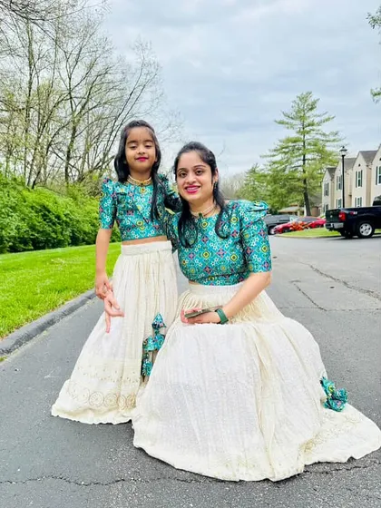 Another beautiful shot of this mother-daughter duo in their custom twinning outfits. The puff sleeves and printed fabric create a stylish, coordinated look.