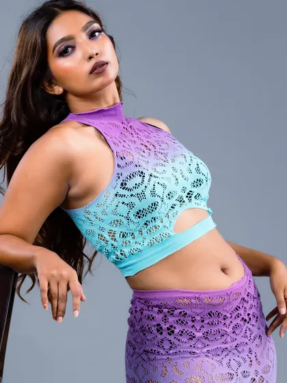 A powerful, seated portrait of the model in the ombre lace outfit.