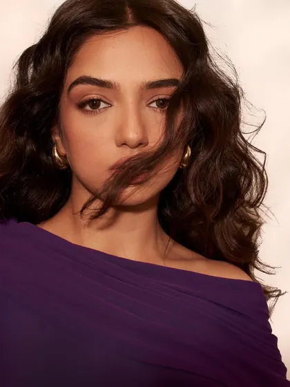 A stunning beauty shot from the Elle India editorial. The focus here is on the mood, with soft, windswept hair and minimal gold hoops to complement the rich color of the dress.