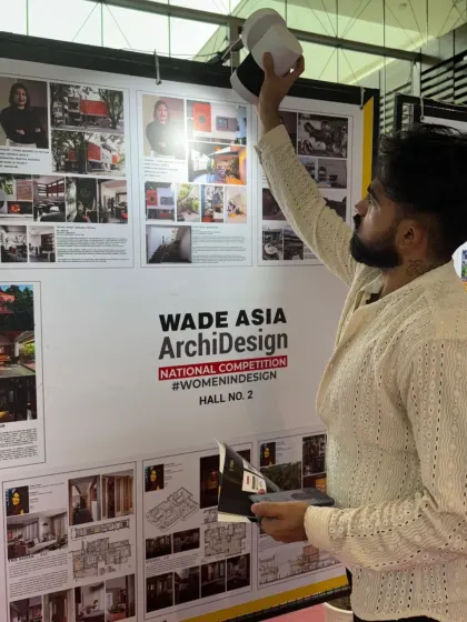My partner, Sandesh, adjusting the lighting on our presentation board at the WADE Asia event.