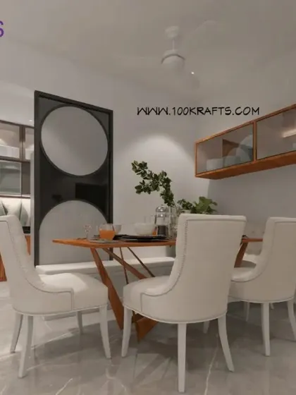 A clean and modern dining setup from the 'Janaki Rainbow' project, showing the open flow into the kitchen area.