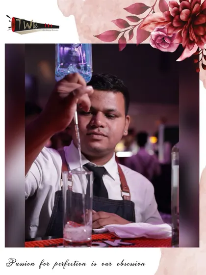 A bartender carefully pours a drink, demonstrating the focus and precision required for perfect mixology.