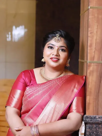 A lovely smile from this wedding guest. Her makeup is fresh and radiant, with a bold red lip that adds a festive touch for her sister's baby shower celebration.