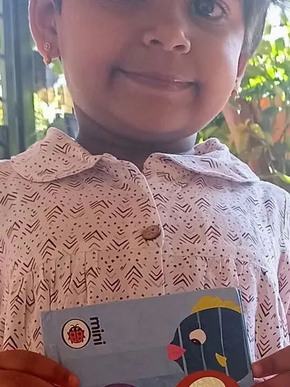 A little girl with her favorite mini board book.