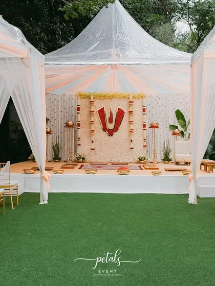 For this Telugu Nalugu ceremony, I designed a clean and sacred space under a tent. The mandap features a backdrop of white chrysanthemums with a prominent red Balaji Nama, creating a divine focal point for the rituals.