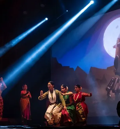 Dancers enact a scene from 'Antariksha Sanchar' under dramatic spotlights, with a custom-designed moon vehicle projected behind them. This sci-fi dance production was a thrilling exploration of new narrative possibilities.