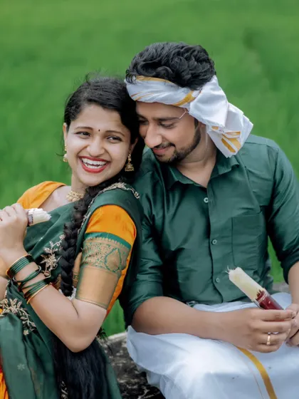 A happy, close-up portrait of a couple enjoying sugarcane in a field, a sweet and authentic moment from their village-themed pre-wedding shoot.