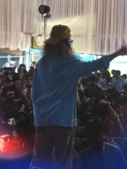 A view from the back of the stage, showing me addressing the large student audience.