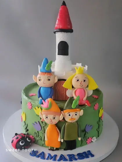 Another view of the Ben 10 and Little Kingdom cake. All the characters, including the ladybug, are handcrafted from fondant for a fun and detailed design.