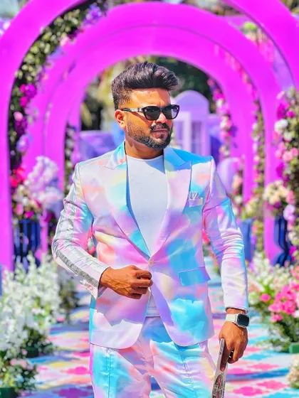 Walking through an archway of flowers, my suit fits the colorful, dreamy vibe perfectly.