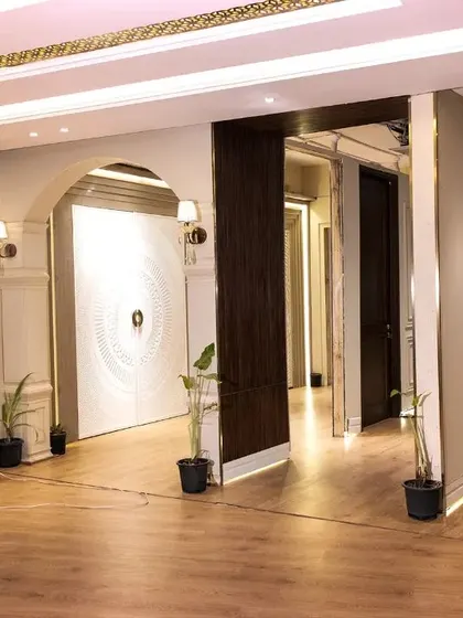 The entrance area of my Ghitorni showroom, featuring a large statement door and an interactive digital display for browsing my extensive catalog.