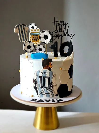 A Messi and Argentina football theme cake for a 10th birthday. This whipped cream cake is decorated with edible prints and fondant footballs.