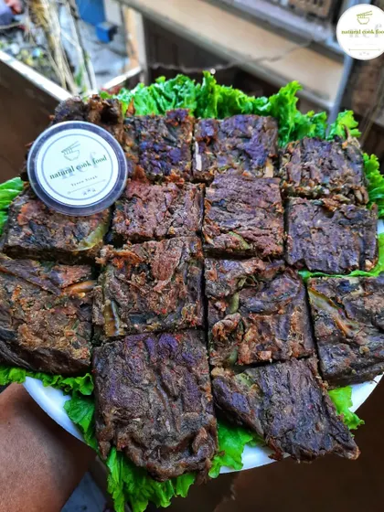 'Paknam', a savory cake made from gram flour, vegetables, and herbs, steamed in turmeric leaves. I've added this traditional item to my menu.